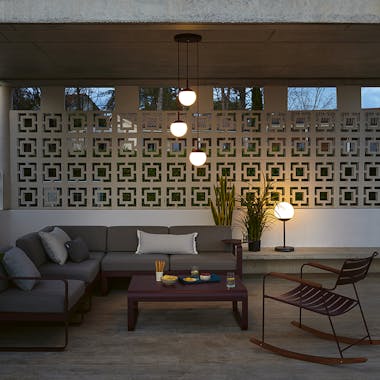 Outdoor undercover porch with modular sofa, rocking chair and lighting