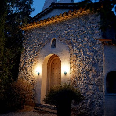 Wall lamps frame door of rustic spanish style building