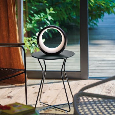 Fermobs Hoopik Indoor Table Lamp in Liquorice Black sits indoors on a table