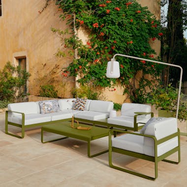 Outdoor lounge setting in French courtyard with outdoor lighting