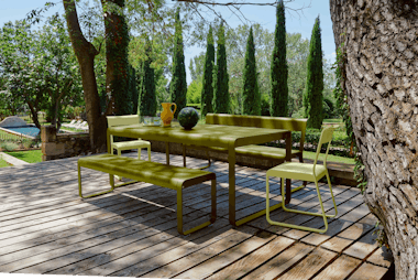 Outdoor dining table with benches on deck