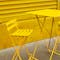 Folding bar table and stools in bright yellow