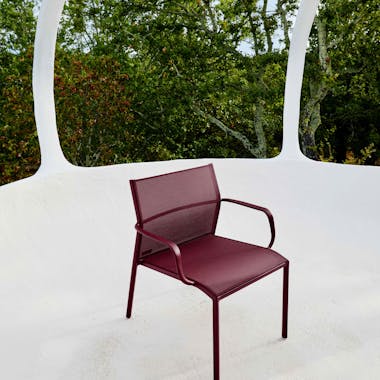 Outdoor armchair in burgundy colour with mesh seat
