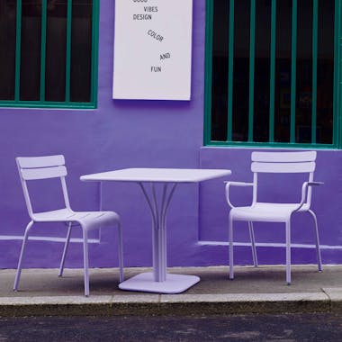 Outdoor table and two chairs in lavender on footpath