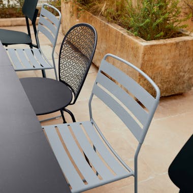 Outdoor chairs in blacks and greys with large charcoal table