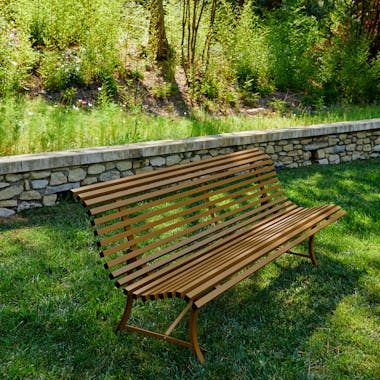 Metal garden bench on grass