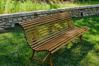 Metal garden bench on grass