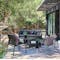 Fermob outdoor casual seating in dark colours dappled shade on a deck