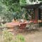 Metal folding outdoor dining table and chairs in a rustic setting