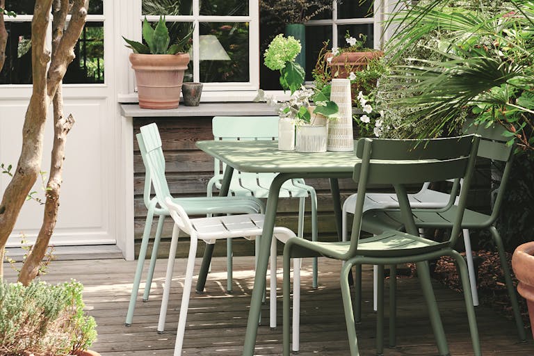 Outdoor dining setting in cactus, cotton white, and ice mint colours fron Fermob