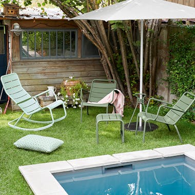 Fermob Luxembourg outdoor furniture in relaxed backyard by pool