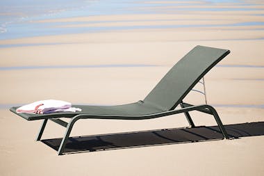 Fermob Alize sunlounger on the beach in the sun