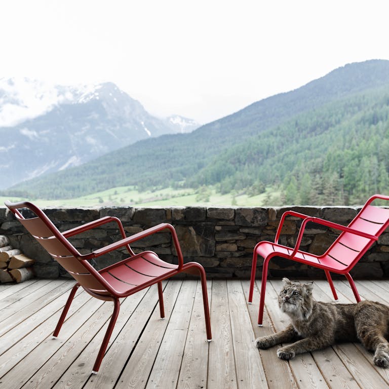 Low armchairs in mountain scenery