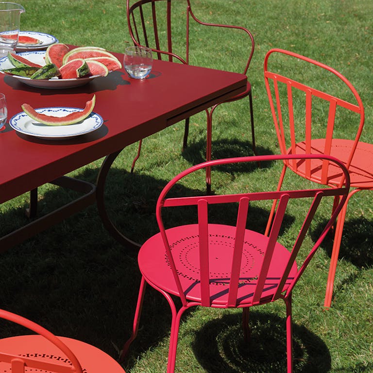 Romane extending outdoor table with chairs on grass