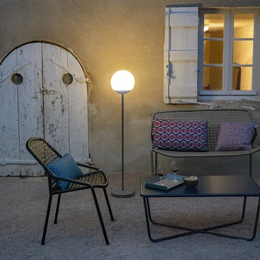 Fermob Croisette outdoor armchair and bench outside a chateau