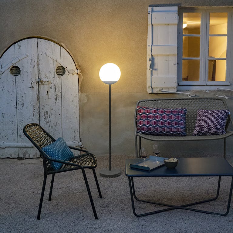 Fermob Croisette outdoor armchair and bench outside a chateau