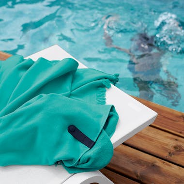 Fermob Colour Mix Fouta towel in Chlorophyll Green on Alize Sunlounge by pool