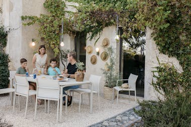 Family dining outdoors with Fermob Cadiz and Calvi collections