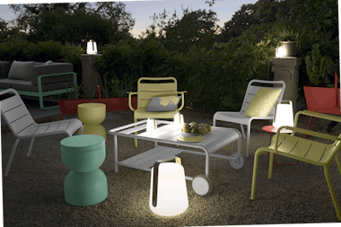 Fermob bamboo lamps in courtyard with Luxembourg lounge chairs