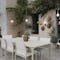 Fermob Calvi table and Cadiz chairs in evening with outdoor lamps