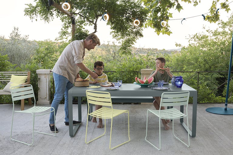 Outdoor Dining Table with chairs and family gathered