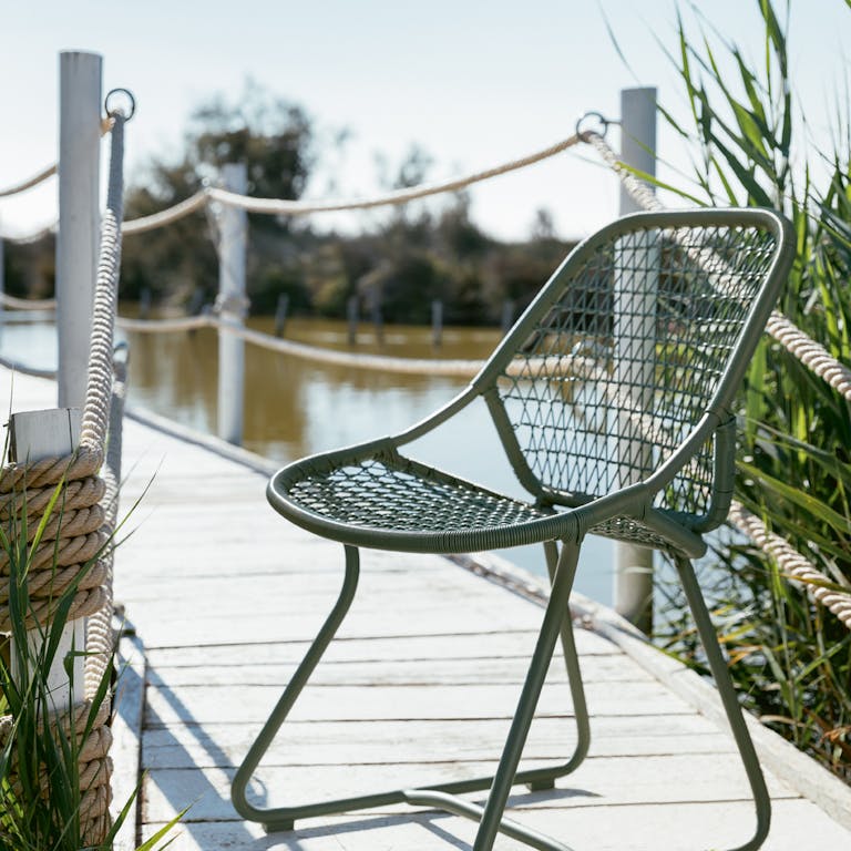 Fermob sixties dining chair in cactus on a jetty