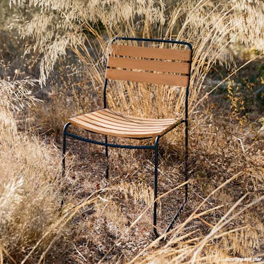 Teak & metal outdoor chair from Fermob in tall grass