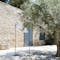 Balad 25cm lamp stands next to an olive tree