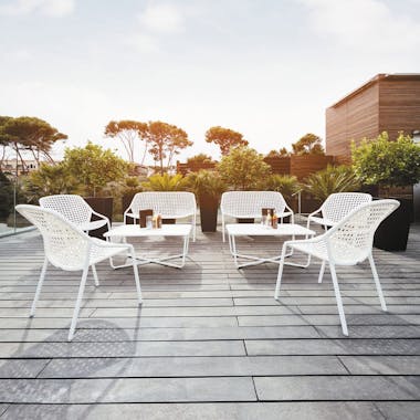 Fermob Croisette white outdoor chairs, sofas and low tables at a bar terrace