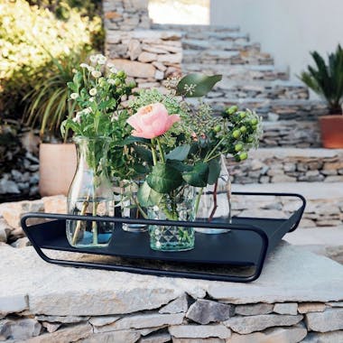 Alto serving tray from Fermob on stone wall