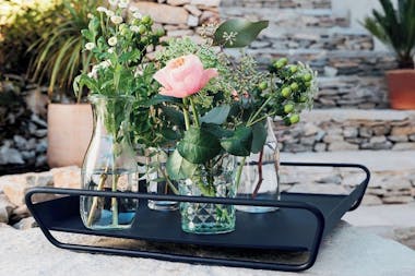 Alto serving tray from Fermob on stone wall