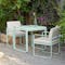 Fermob Bellevie dining armchair with cushions in courtyard