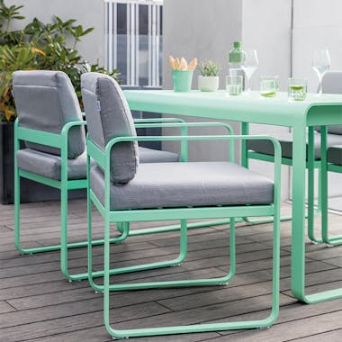 Fermob Bellevie dining armchair in opaline green on roof terrace