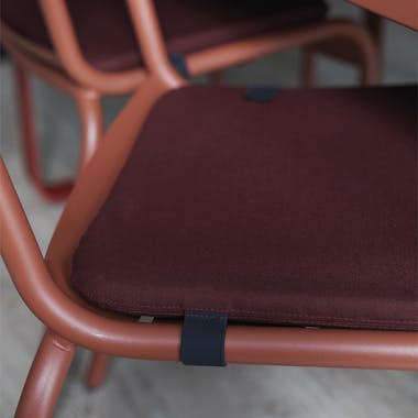 Fermob Colour Mix cushion in burgandy on Luxembourg chair