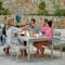 Family gathered outdoors at Fermob Bellevie outdoor dining table and benches