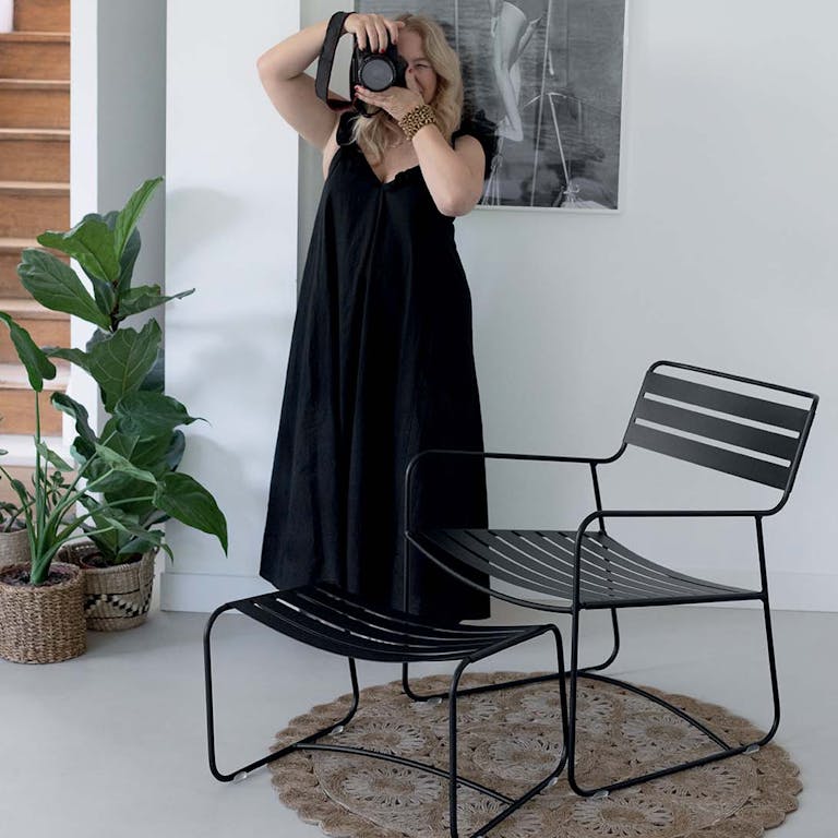 Woman taking photo with Fermob Surprising Low Armchair