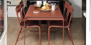 Fermob Bellevie dining table with Luxembourg chairs in kitchen