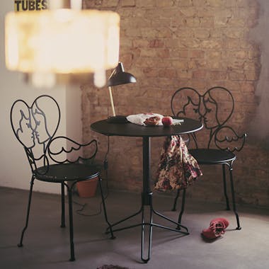 Fermob Flower pedestal table with exposed brick wall