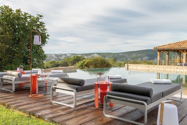 Fermob Bellevie sunloungers poolside at boutique hotel