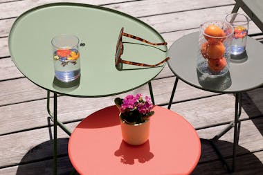 Fermob Cocotte low table and stools nested together with sunlounge