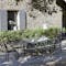 Fermob Costa Extending outdoor table and chairs in rustic French courtyard
