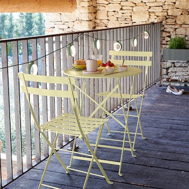 Fermob Bistro folding table and two chairs in Frosted Lemon