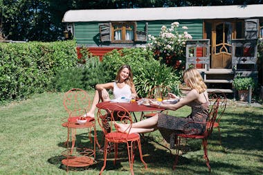 Friends enjoying the Fermob Montmartre table and chairs outside cabin
