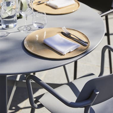 Close up of Fermob So'o table and Studie armchair in Lapilli Grey
