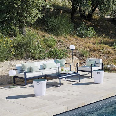 Fermob Bellevie 3 seater sofa and armchair in Deep Blue by a pool