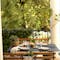 Fermob Bistro table with timber slat chairs on covered terrace
