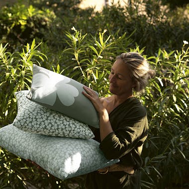 Lady carrying Fermob Trefle outdoor cushions
