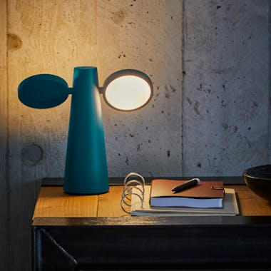 Fermob Oto lamp lights a desk and a leather journal